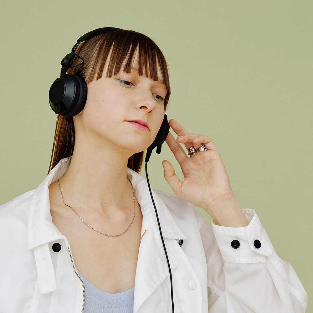 A girl using Pioneer DJ HDJ-CX DJ Headphones