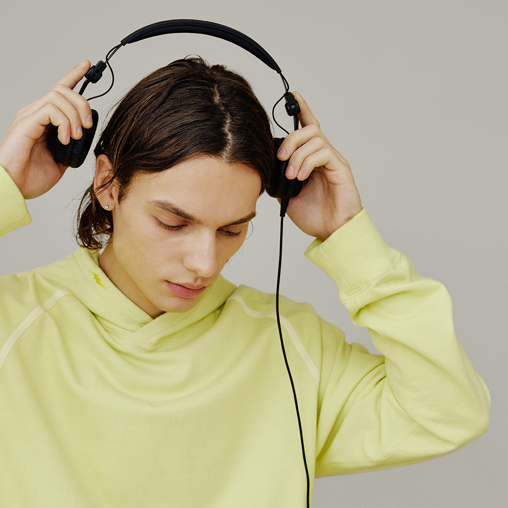 A boy using Pioneer DJ HDJ-CX DJ Headphones showing its robust construction